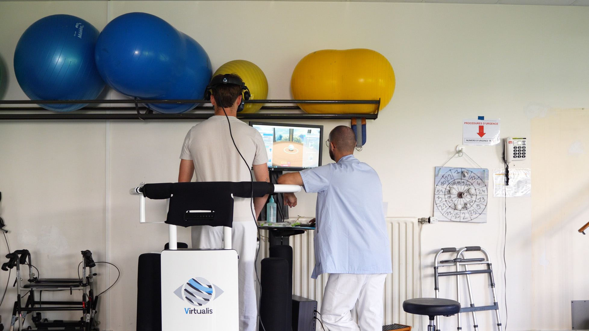 Patient using virtual reality rehabilitation machine with therapist