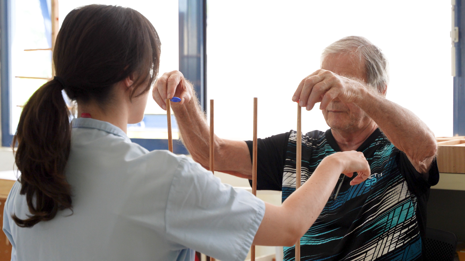 Senior man doing physical therapy with therapist