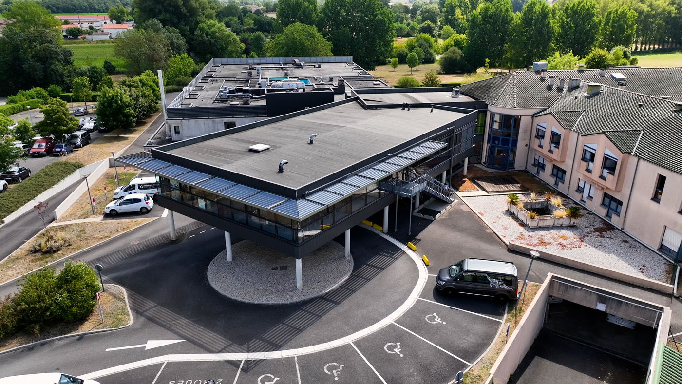 Aerial view of modern building with parking area
